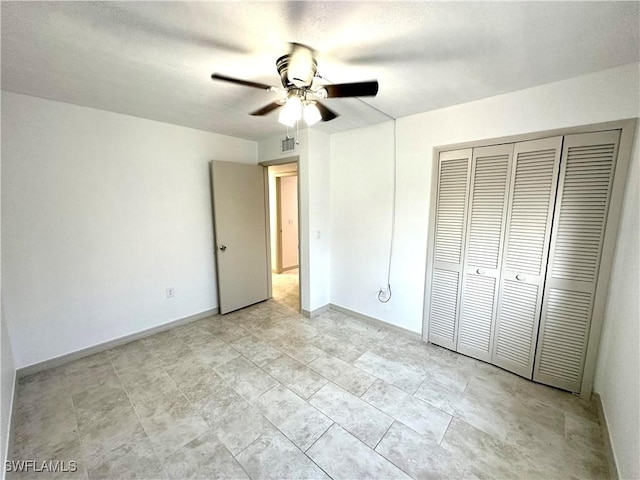 unfurnished bedroom with baseboards, visible vents, ceiling fan, a textured ceiling, and a closet