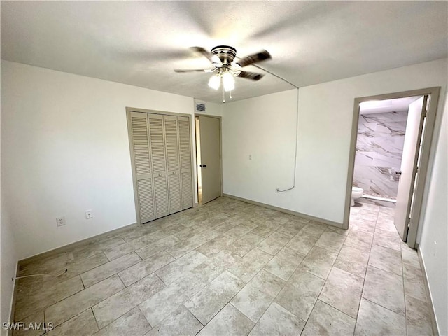 unfurnished bedroom with visible vents, a closet, connected bathroom, and a ceiling fan