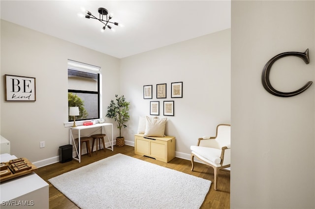 living area featuring wood finished floors and baseboards