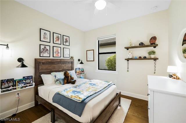 bedroom with a ceiling fan, dark wood-style flooring, and baseboards