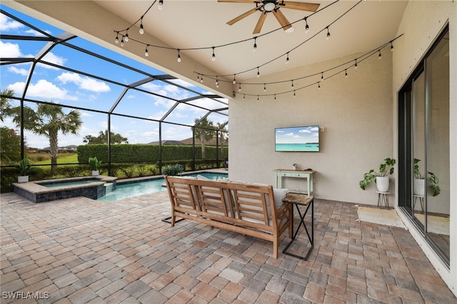 view of patio / terrace featuring glass enclosure, ceiling fan, and a pool with connected hot tub