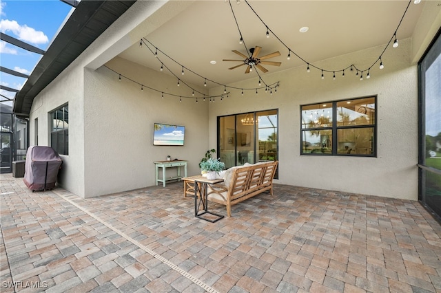 view of patio with a lanai, ceiling fan, and an outdoor hangout area