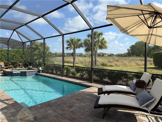 view of swimming pool with a patio, a pool with connected hot tub, and glass enclosure