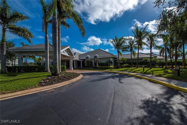 exterior space featuring driveway and a front yard