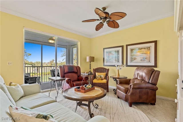 living area with baseboards, ceiling fan, and crown molding