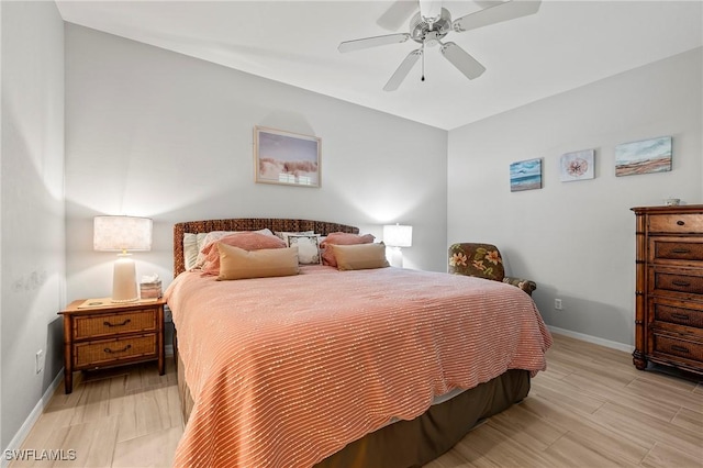 bedroom featuring ceiling fan, light wood-type flooring, and baseboards