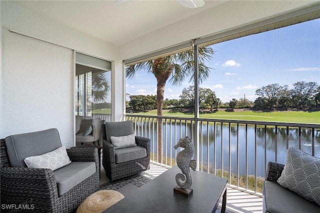 sunroom / solarium featuring a water view