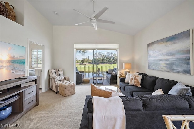 living area featuring a ceiling fan, lofted ceiling, and light carpet