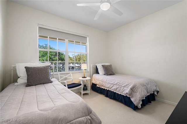 bedroom with carpet, baseboards, and a ceiling fan