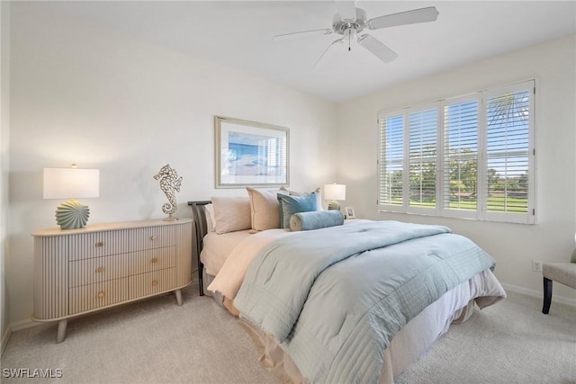 carpeted bedroom featuring ceiling fan and baseboards