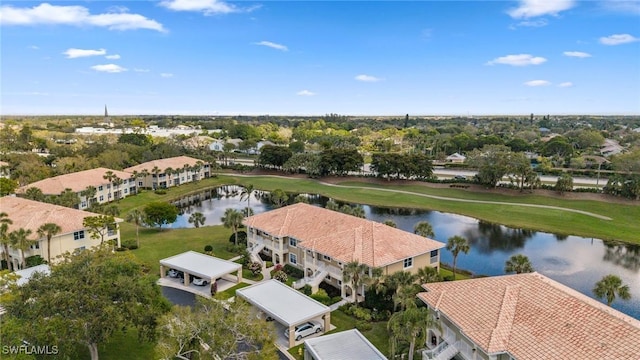 birds eye view of property with view of golf course and a water view