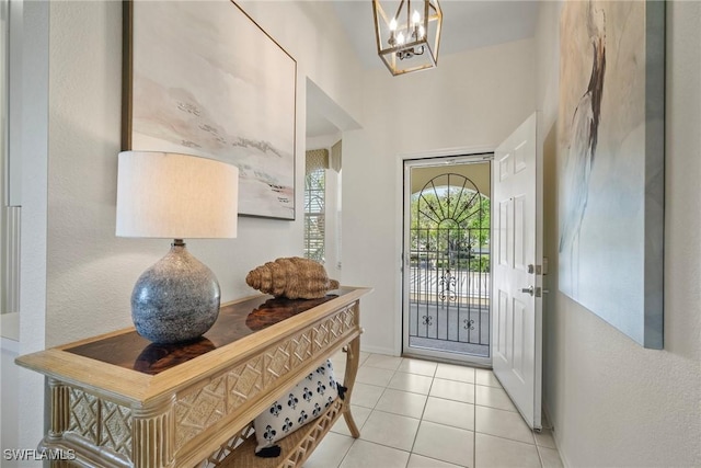 entryway with a chandelier and tile patterned floors