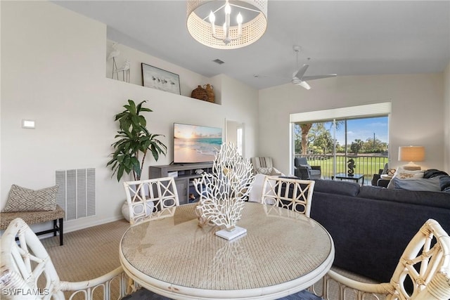 carpeted dining space with lofted ceiling, visible vents, baseboards, and ceiling fan with notable chandelier