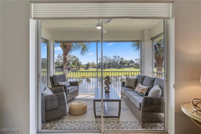 sunroom / solarium featuring a water view