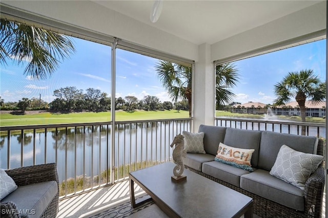 sunroom / solarium with a water view