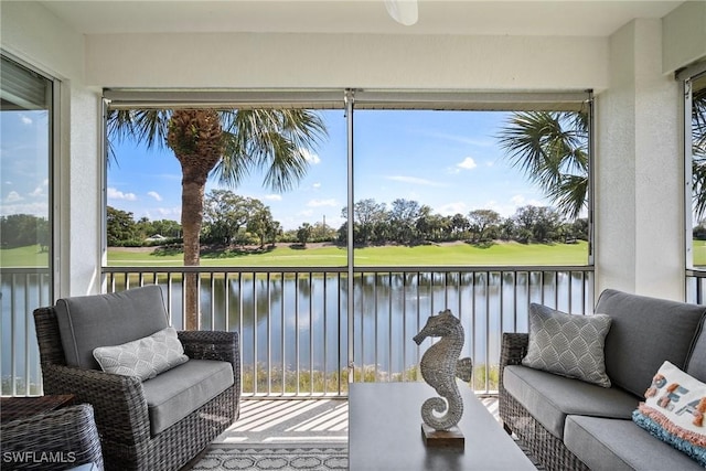 sunroom / solarium with a water view and plenty of natural light