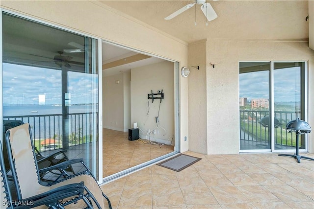 view of patio / terrace with a ceiling fan and a balcony