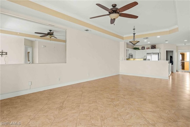 unfurnished living room with baseboards, a raised ceiling, crown molding, and recessed lighting