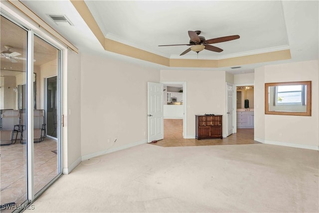 unfurnished bedroom with carpet floors, crown molding, a raised ceiling, visible vents, and baseboards