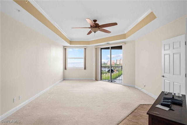 living room with light carpet, ornamental molding, a raised ceiling, and baseboards