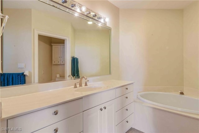 full bathroom featuring a garden tub and vanity