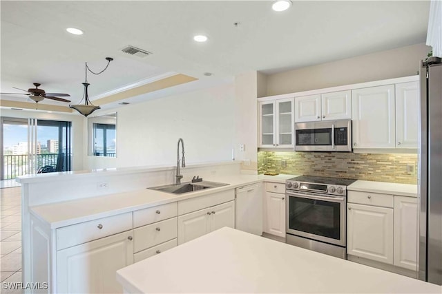 kitchen with tasteful backsplash, visible vents, appliances with stainless steel finishes, a sink, and a peninsula