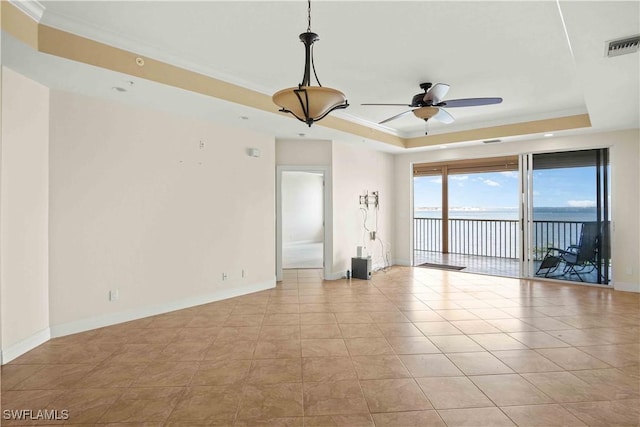 spare room with visible vents, baseboards, a raised ceiling, a ceiling fan, and crown molding