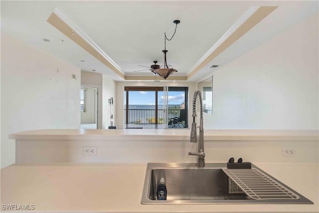 kitchen with visible vents, a tray ceiling, a ceiling fan, and crown molding