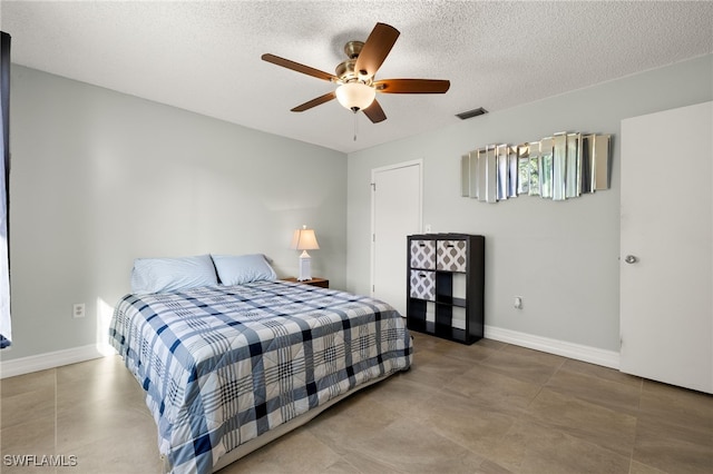 bedroom featuring visible vents, ceiling fan, a textured ceiling, and baseboards