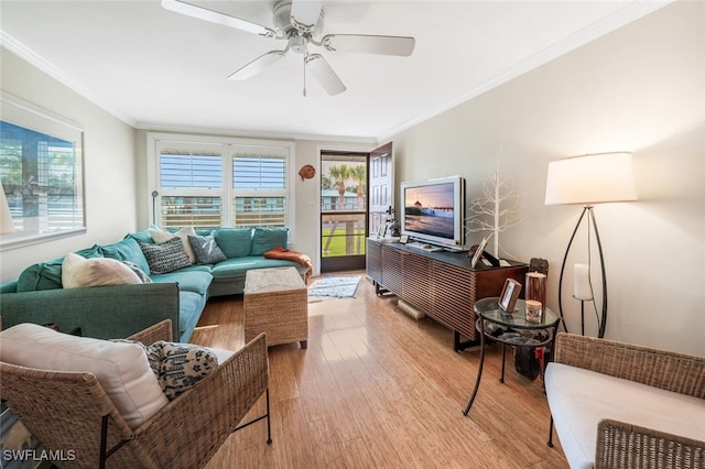 living room with ceiling fan, ornamental molding, and wood finished floors