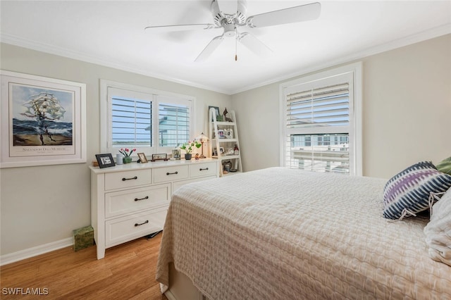 bedroom with ornamental molding, baseboards, and light wood finished floors