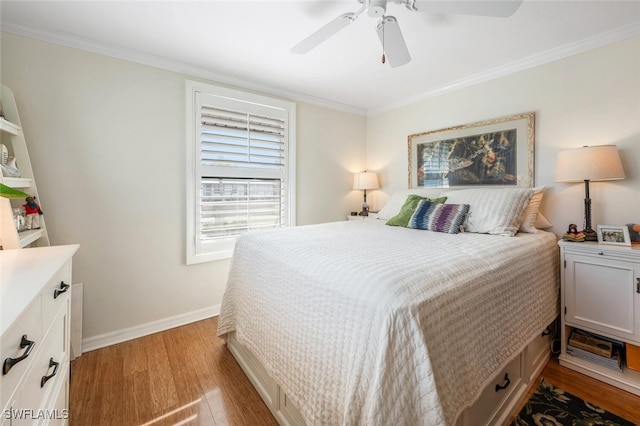 bedroom featuring a ceiling fan, baseboards, ornamental molding, and wood finished floors