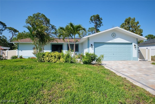 single story home with a front lawn, fence, stucco siding, driveway, and an attached garage