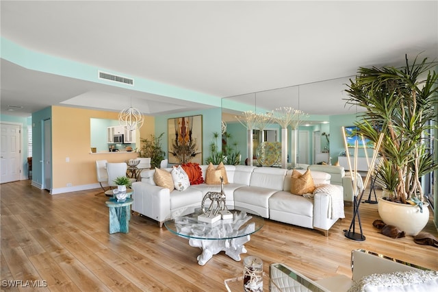 living area with light wood-type flooring, baseboards, and visible vents