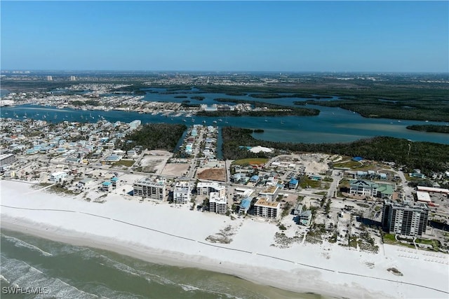 birds eye view of property featuring a water view and a beach view