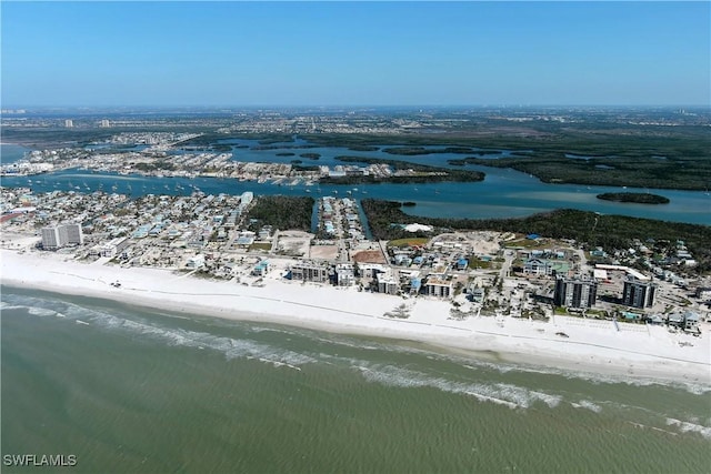 drone / aerial view featuring a beach view and a water view