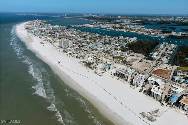 bird's eye view featuring a water view and a beach view