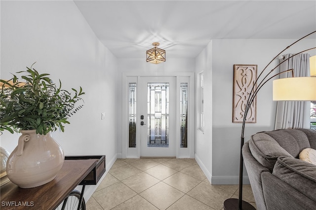 foyer entrance featuring light tile patterned floors and baseboards