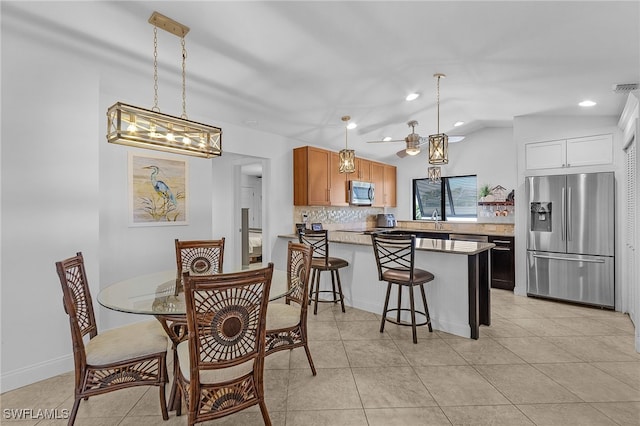 dining area with light tile patterned floors, visible vents, vaulted ceiling, and recessed lighting