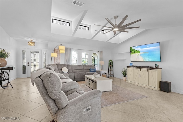 living room featuring light tile patterned floors, ceiling fan, high vaulted ceiling, visible vents, and baseboards