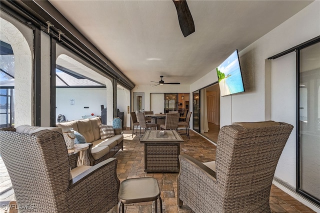 interior space featuring a lanai, ceiling fan, and outdoor lounge area