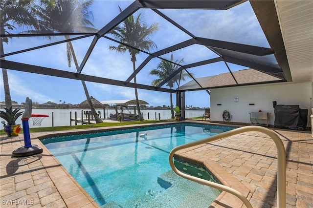 pool with a patio, a boat dock, a water view, and a lanai