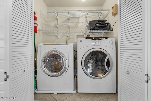 laundry area with tile patterned floors, laundry area, and separate washer and dryer