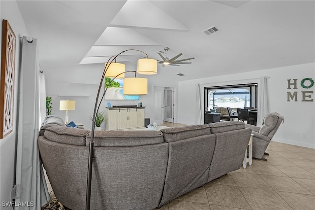 living area with lofted ceiling, visible vents, baseboards, and light tile patterned flooring