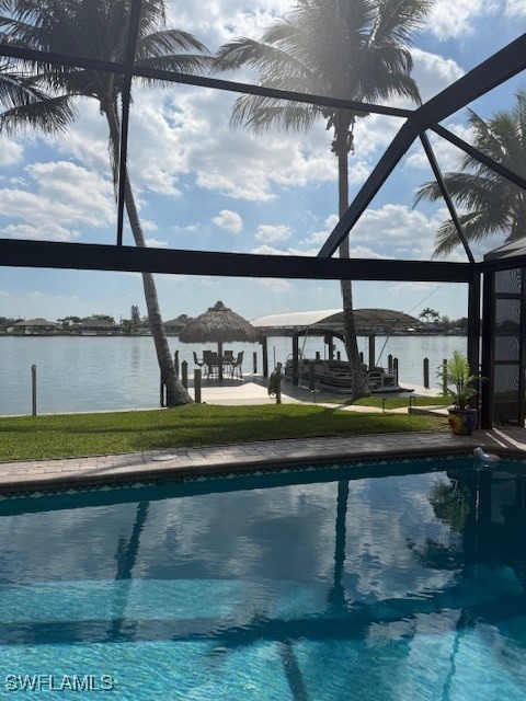 pool with glass enclosure and a water view