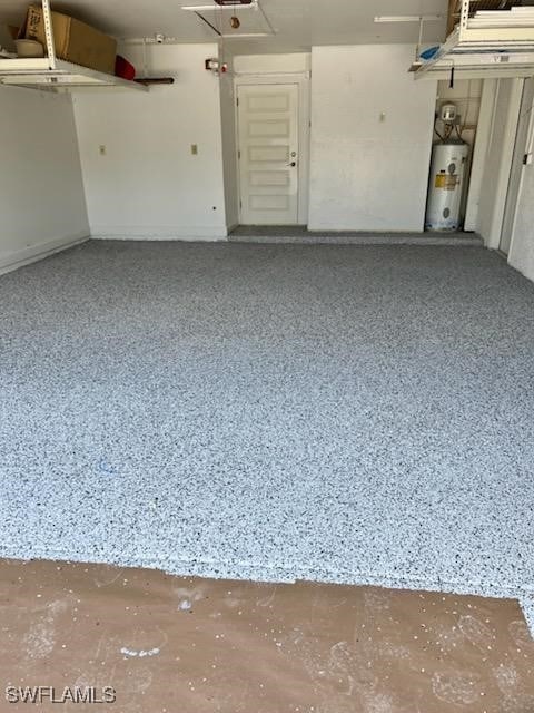 garage featuring electric water heater and a garage door opener