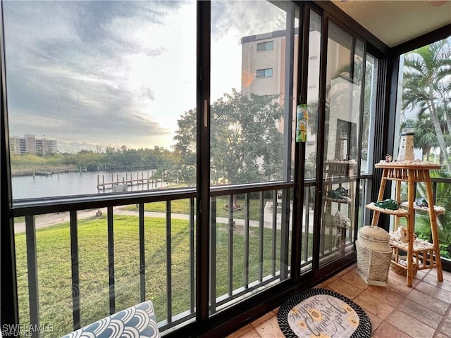 sunroom featuring a water view and plenty of natural light