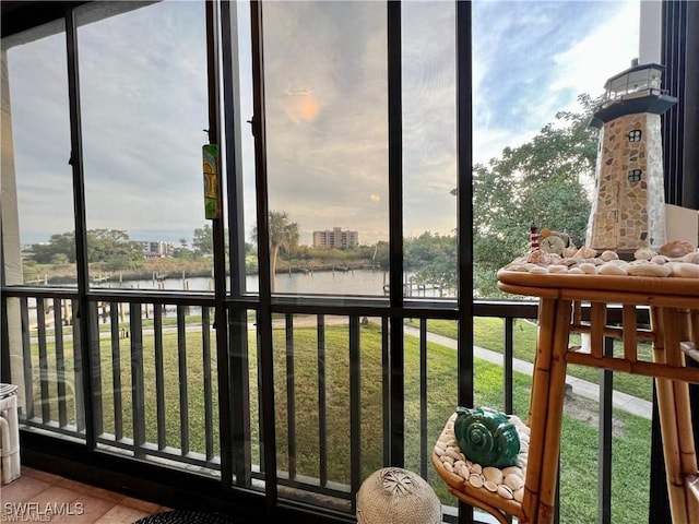 unfurnished sunroom with a water view