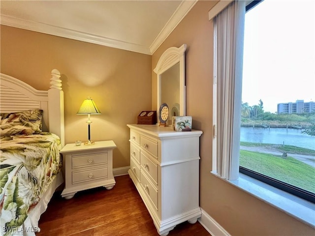 bedroom with ornamental molding, dark wood-style flooring, and baseboards