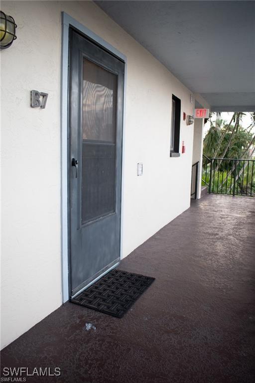 doorway to property with stucco siding